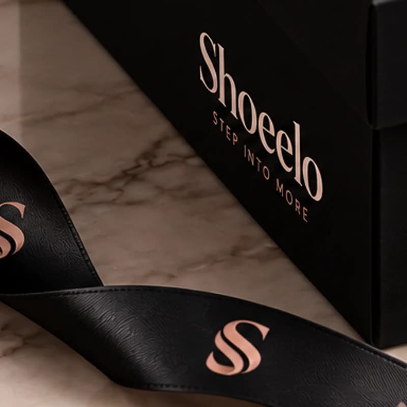 Black satin ribbon printed with the S monogram